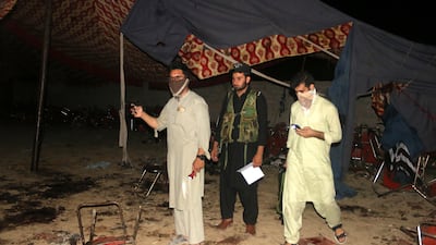 People survey the site of a blast targeting a gathering of hardline political party Jamiat Ulma-e-Islam-Fazl in Bajaur, Pakistan on Sunday. EPA