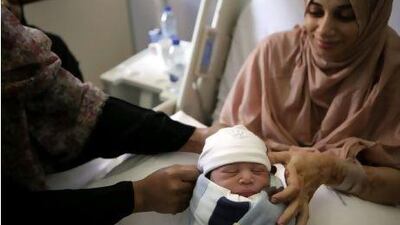 Salema Al Ghunami holds her newborn son Falah Al Ameri, born at 12.01am, 11/11/11, at the Corniche Hospital.