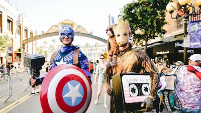 Cosplayers are dressed as Captain America and Groot. AFP