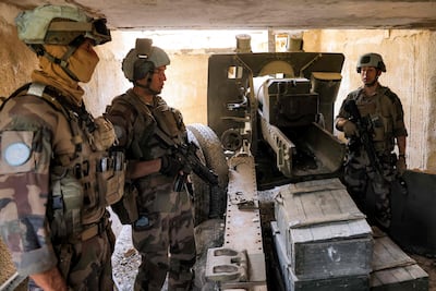 Peacekeepers from UNIFIL stand by an artillery gun at a fortified position formerly held by Hezbollah in south Lebanon. AFP