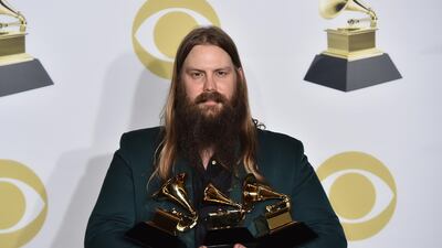 Chris Stapleton poses in the press room with his awards for best country solo performance for "Either Way", best country song for "Broken Halos" and best country album for "From a Room: Volume 1" at the 60th annual Grammy Awards. Charles Sykes / Invision / AP