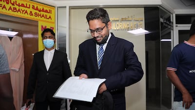 Haseeb Nadeem, from Pakistan, examines the paperwork for his application.