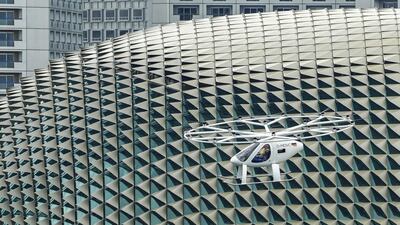 A prototype of a Volocopter air taxi in flight during test flight over Marina Bay on October 22, 2019 in Singapore. Getty