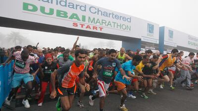 And they're off: Runners in the 10K run sprint off the starting line in their race.
