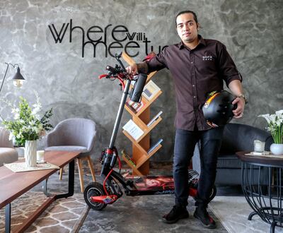 Barista Sam Soliguen has been using his e-scooter for his commute to work for a number of months. Victor Besa/The National