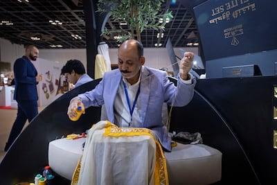 A ceremonial Emirati bisht being hand stitched by Kalash Gallery. Antonie Robertson / The National