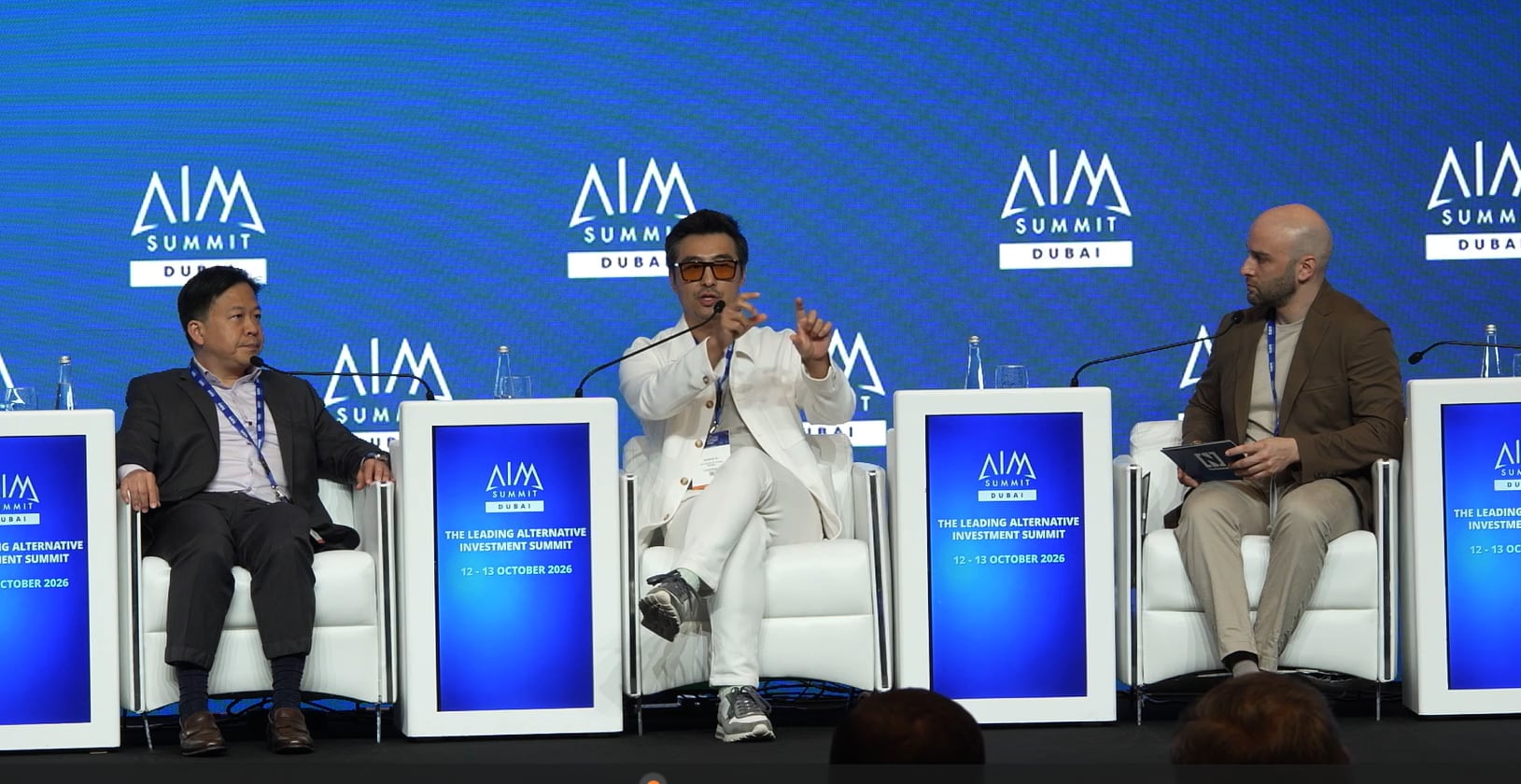 Joseph Zeng, founder and CIO of Arcadia Fund Management, and Weber Su, LinkerBot’s vice president and head of global markets, with The National’s Salim Essaid at AIM Summit in Dubai. Photo: AIM Summit