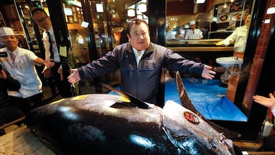 Kiyoshi Kimura, President of Japanese sushi chain Sushi-Zanmai, shows off his 275kg bluefin tuna at the first auction of the new year at Toyosu Market in Tokyo. EPA