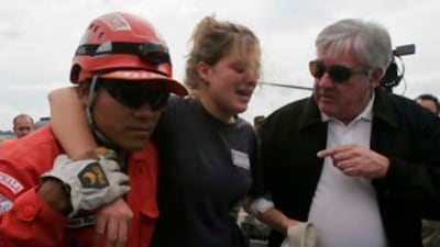 Rescue workers help Sarah Jensen, from Amery, Wisconsin, who survived the plane crash in Guatemala.