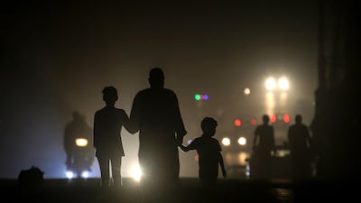 Palestinian refugees walk in the streets during a power outage in Al Shati refugee camp, north of Gaza City, Gaza Strip. EPA