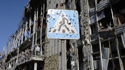 A bullet-ridden road sign in front of the destroyed Donetsk international airport. Aleksey Filippov / AFP Photo
