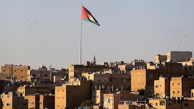 A Jordanian flag flies over the city in Amman. Getty Images