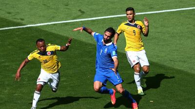 Georgios Samaras of Greece is challenged by Juan Camilo Zuniga of Colombia during their Group C match at the 2014 World Cup in Belo Horizonte, Brazil on Saturday. Ian Walton / Getty Images