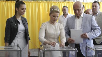Former prime minister and presidential candidate Yulia Tymoshenko, centre, accompanied by her daughter Yevgenia, left, and husband Oleksander, right, casts her vote during a presidential election at a polling station in Dnipropetrovsk on May 25, 2014. Valentyn Ogirenko/Reuters