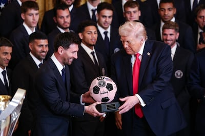 Inter Miami's Lionel Messi, left, presents US President Donald Trump with a ball trophy in the team's signature pink colour during an event in the East Room of the White House. Bloomberg