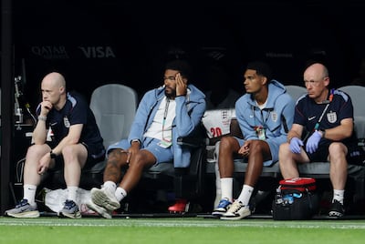 Injured England defenders Reece James and Jarell Quansah, centre left and right, on the bench during the last-32 game against DR Congo. Getty Images