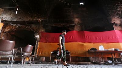 A rebel fighter from Al Jabha Al Shamiya (Levant Front) in the compound of the justice palace Aleppo, Syria, Syria on July 5, 2016. Abdalrhman Ismail / Reuters