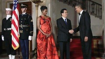 President Barack Obama and first lady Michelle Obama greet China's President Hu Jintao at the Grand Staircase as they arrive for a state dinner at the White House in Washington, Wednesday, Jan. 19, 2011. (AP Photo/Carolyn Kaster) *** Local Caption *** DCSA144_Obama_US_China.jpg