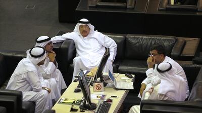 Traders at the Dubai Financial Market at Dubai World Trade Centre. Markets were flat today. Pawan Singh / The National