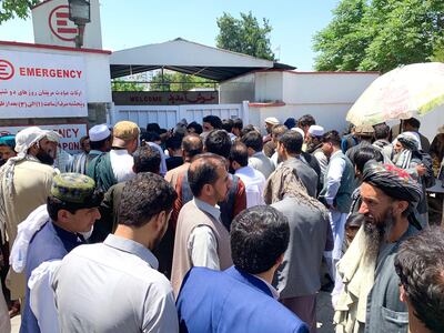 Crowds of family members wait outside the Emergency Hospital waiting anxiously for news of their loved ones injured in the Taliban attack on Monday morning. Photo by Hikmat Noori for The National