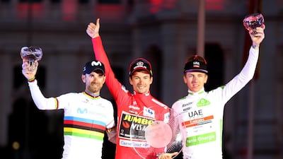 All three celebrate on the podium in Madrid at the end of Vuelta a Espana cycling race. EPA