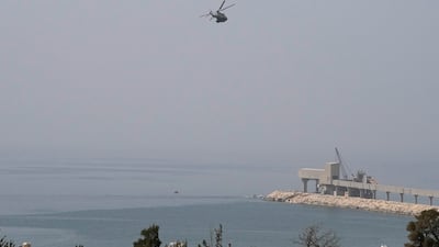 A helicopter searches for missing people after a boat capsized near Tripoli in April. The Lebanese army have arrested 64 people who they say were attempting to flee ‘illegally’ by sea. AP