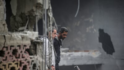 Palestinians inspect a house neighbouring Al Qassam Mosque, both destroyed as a result of an overnight Israeli air strike in Gaza on Wednesday. EPA