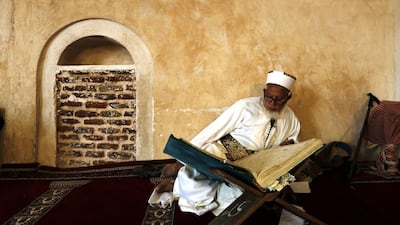 A Yemeni man reads the Quran at a mosque in Sanaa. EPA