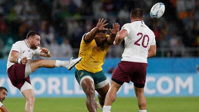 Georgia scrum-half Vasil Lobzhanidze, left, kicks the ball past Australia's prop Taniela Tupou. AFP