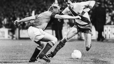 Barcelona's Johan Cruyff running at Ipswich Town defender John Stirk during the 1977 Uefa Cup tie at Portman Road. Getty
