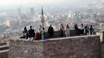 Visitors at the Ankara Castle in Ankara, Turkey, where the annual income to be happy is $10,742. Photo: AFP