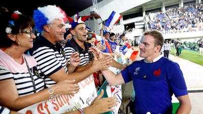 France's Arthur Iturria, right, is celebrated by supporters following their Rugby World Cup Pool C game at Fukuoka Hakatanomori Stadium between France and the United States in Fukuoka, Japan. France defeated the United States 33-9. AP