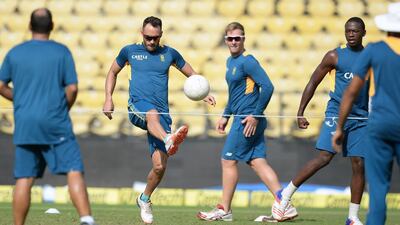 South Africa's Faf du Plessis (C) plays football during a training session ahead of the third Test cricket match between India and South Africa at The Vidarbha Cricket Association Stadium in Nagpur on November 24, 2015. AFP PHOTO / Indranil MUKHERJEE---- IMAGE RESTRICTED TO EDITORIAL USE - STRICTLY NO COMMERCIAL USE ----