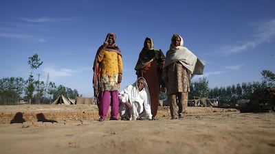 Muslim women wait for their husbands before going to cast their votes for the general election, at a relief camp at Parla village in Muzaffarnagar district, in the northern Indian state of Uttar Pradesh. Anindito Mukherjee / Reuters