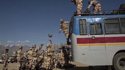 Security force soldiers on election duty unload equipment off a bus as they leave a central collection point to head for a polling station.