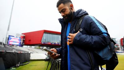 India captain Virat Kohli leaves after rain stopped play during the first 2019 Cricket World Cup semi-final at Old Trafford on Tuesday. Jason Cairnduff / Reuters