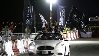 Sebastian Vettel, right, and Daniel Ricciardo wave to the crowd during an Infiniti Red Bull Racing show run in Dubai.