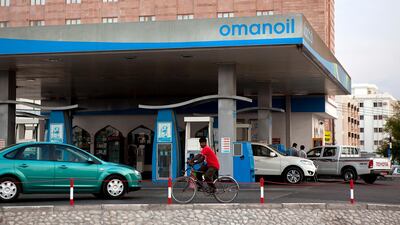 A man passes an Oman Oil gas station in Muscat. Silvia Razgova/The National