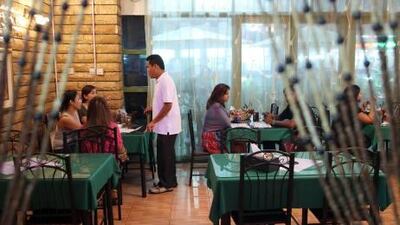 Tropical flowers hang above beaded doorways and Indonesian soap operas play on a television at the back of the restaurant.