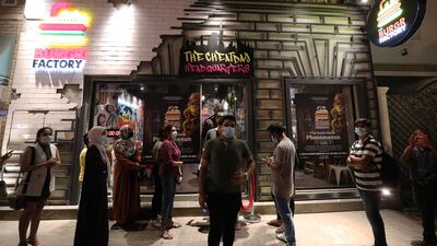 Customers lined up outside the new restaurant for free burgers. Pawan Singh/The National