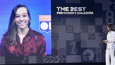 The Best FIFA Women's Goalkeeper 2021 award winner Christiane Endler (on screen) speaks with Britain's Fara Williams. AFP