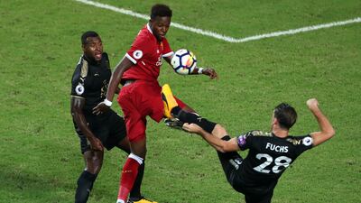 Liverpool's Divock Origi battles for the ball. Stanley Chou / Getty Images
