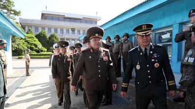 A handout photo made available by the South Korean Ministry of National Defense shows North Korean Lt. Gen. An Ik-san (L) crossing to southern side for the meeting with South Korea's chief delegate Major Gen. Kim Do-gyun (not pictured) near the Peace House on the southern side of the border truce village Panmunjom in Paju, South Korea, 31 July 2018. EPA / MINISTRY OF NATIONAL DEFENSE