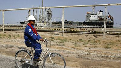 Qatar has invited all 13 members of Opec and major non-Opec producers to Doha on April 17 for another round of talks. pictured, an Iraqi engineer cycles past a tanker in Basra. AP Photo