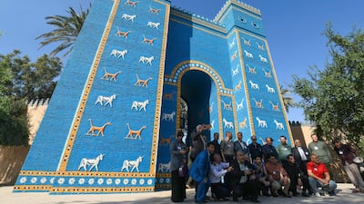 Visitors pose for a picture in front of a replica of the Gate of Ishtar at the archaeological site of ancient Babylon, about 100Km south of the Iraqi capital. AFP