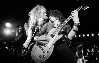 Guns N’ Roses, with original members Axl Rose, left, and Slash, perform in Los Angeles in 1985 Getty
