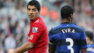 Luis Suarez, the Liverpool striker, has an altercation with Patrice Evra, the Manchester United defender, which will be investigated by the English FA. Lindsey Parnaby / EPA