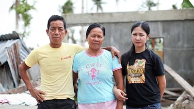 Aiza Tonida, right, with her parents Maxima and Gualberto Tonido standing at what remain of their house in Barangay Mering, Tabon-Tabon, Leyte. (Joey Reyna for The National / April 9, 2014)