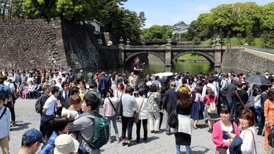 People gather in the compound near Imperial Palace in Tokyo. Japan has new Emperor Naruhito to perform his first ritual after succeeding the Chrysanthemum Throne from his father Akihito who abdicated the night before. AP