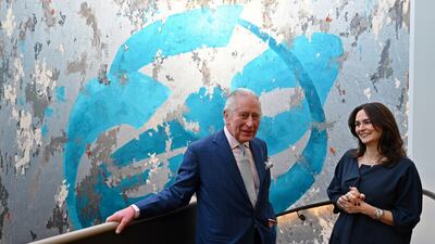 Speaking with Iranian artist Shahrzad Ghaffari in front of her mural artwork, called Oneness, 2022. Getty Images